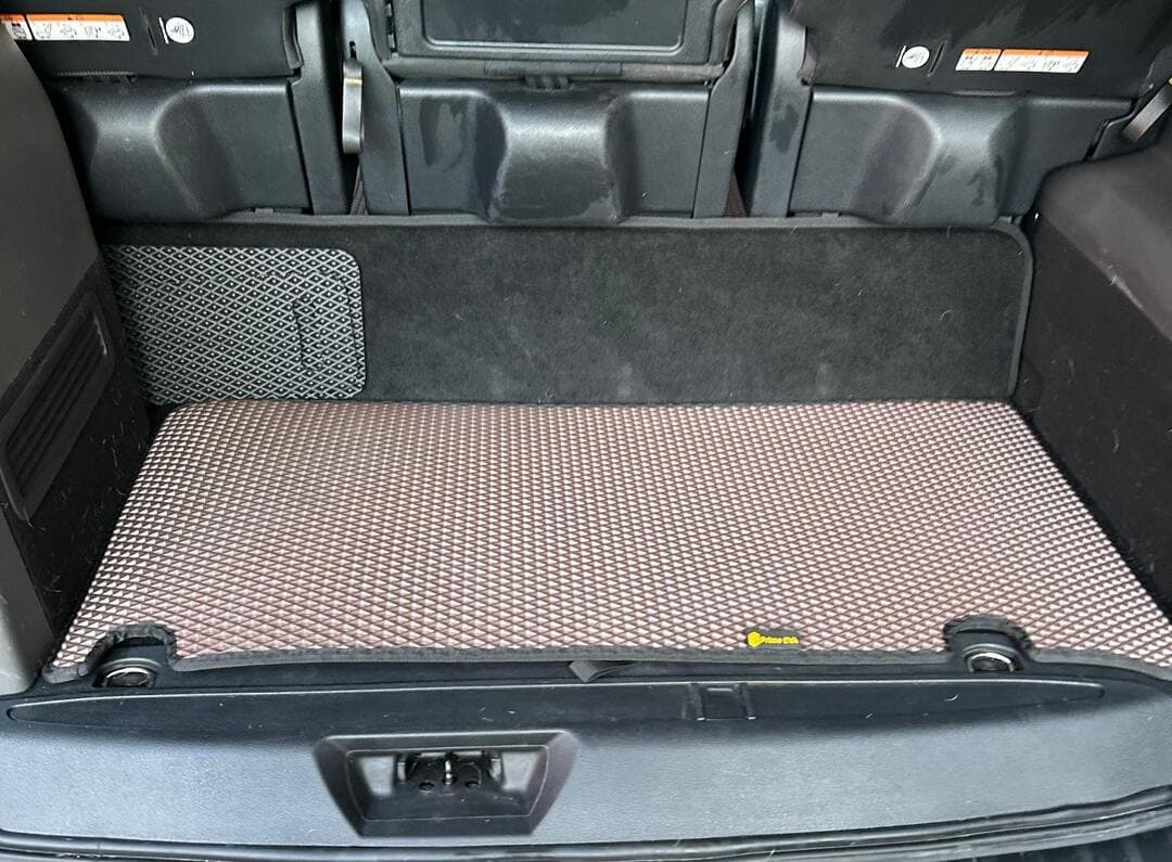 Brown EVA trunk mat fitted in the rear cargo area of a vehicle, offering durable and stylish protection.