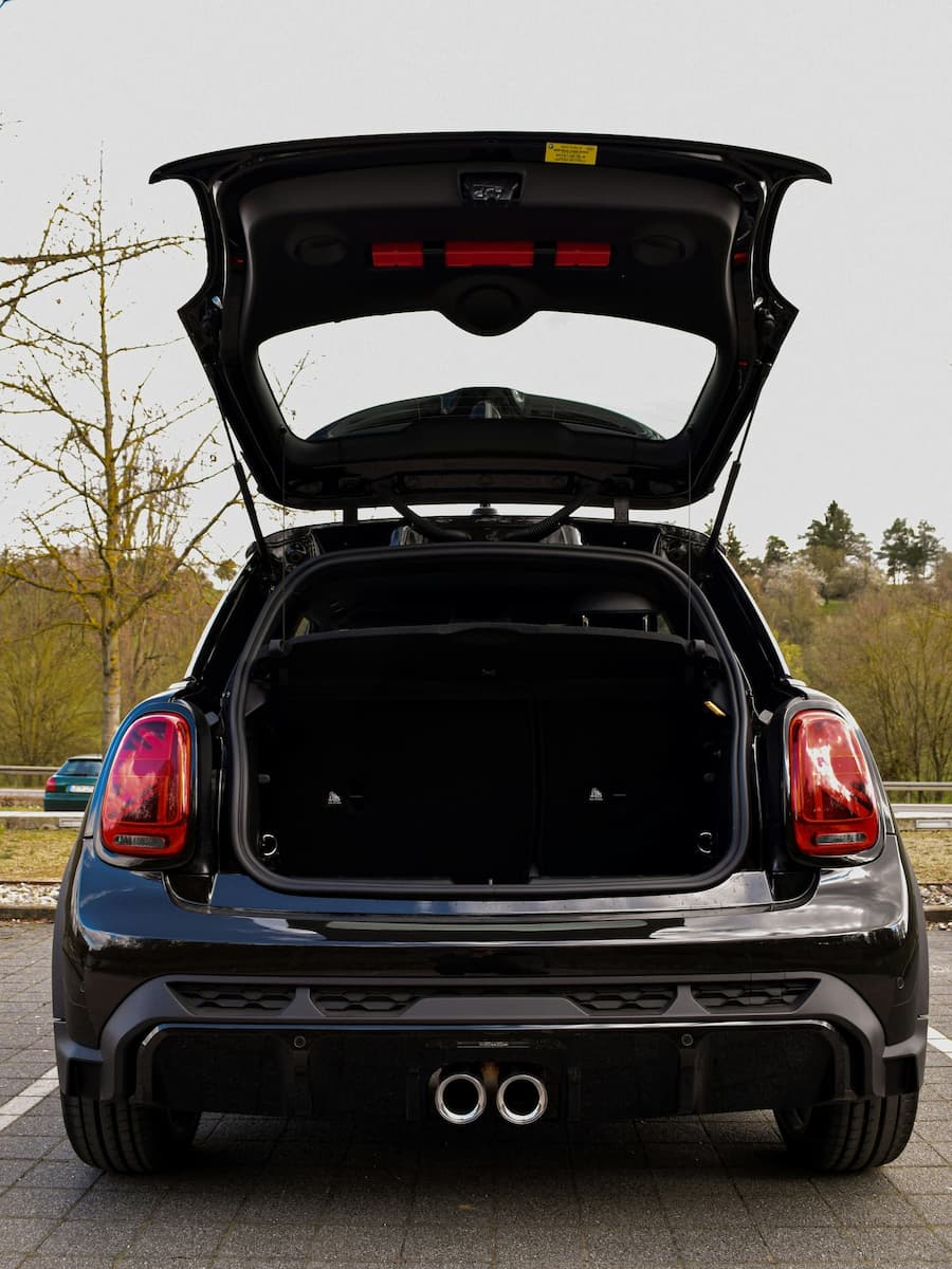 Open view of a car trunk with lifted hatchback during daytime.