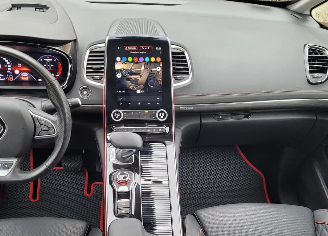 Black EVA car floor mats with red trim in a modern vehicle interior.