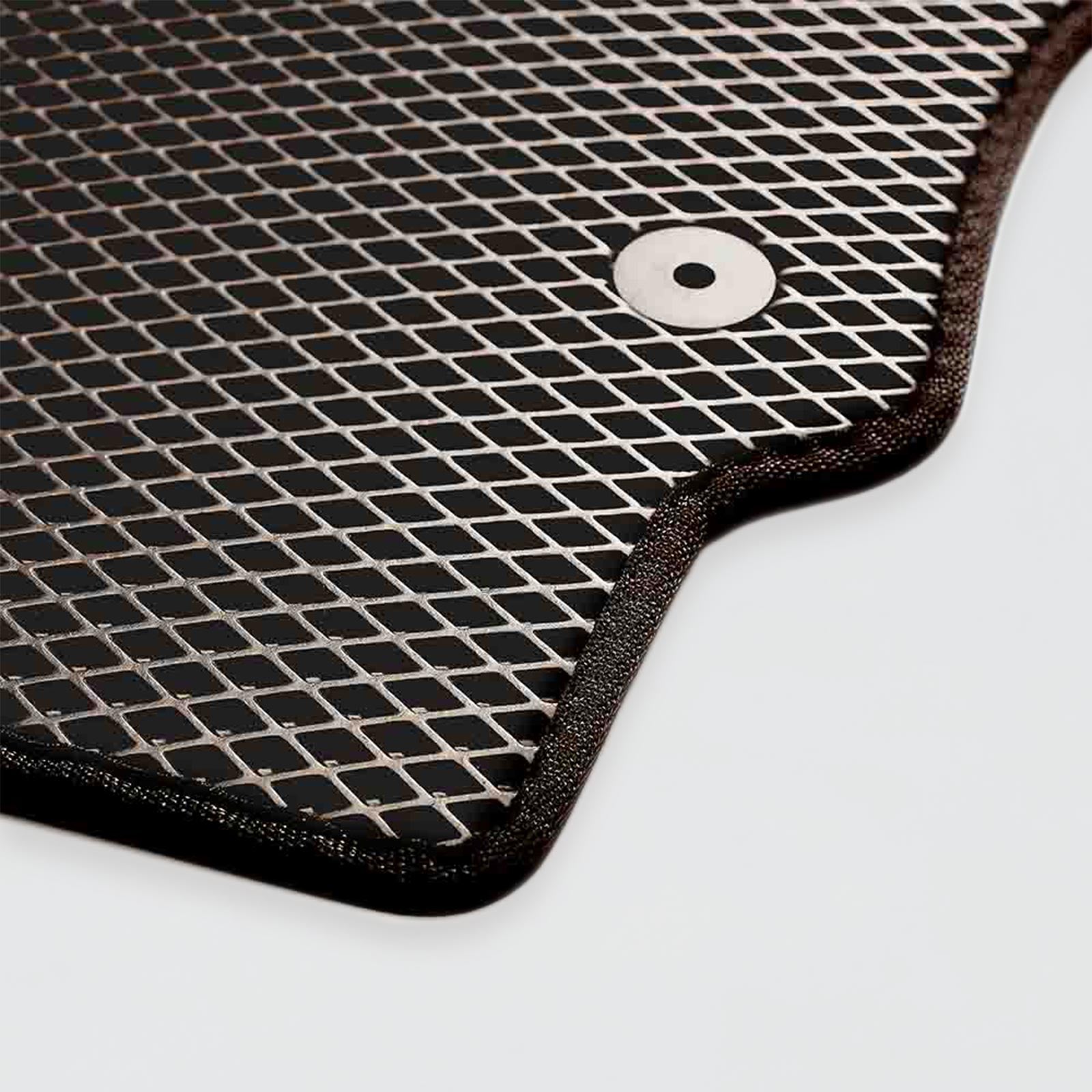 Black mesh automotive floor mat with a circular attachment hole