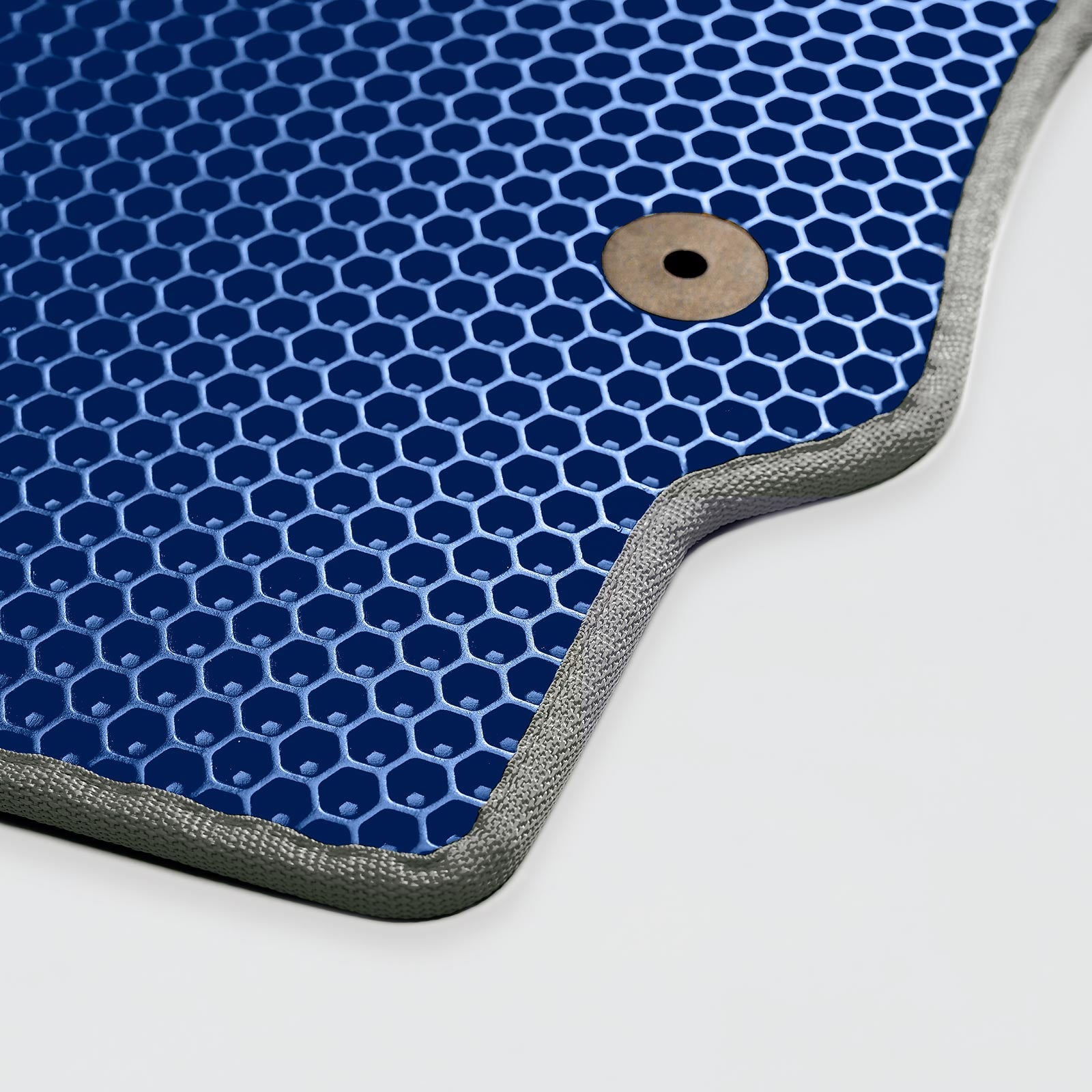 Blue honeycomb-patterned surface with a metallic edge and a hole for attachment.