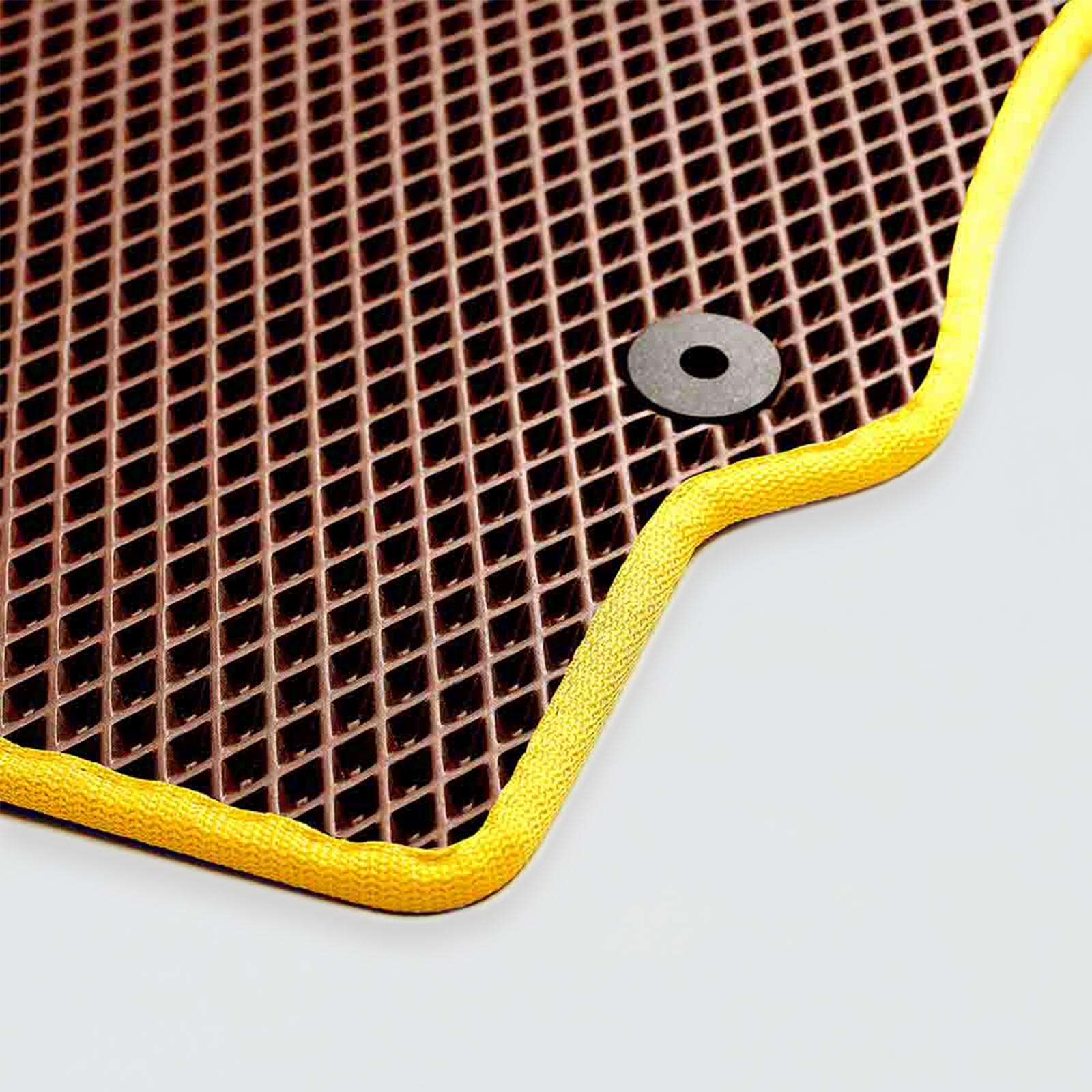 Brown textured mat with a yellow border and a black eyelet.