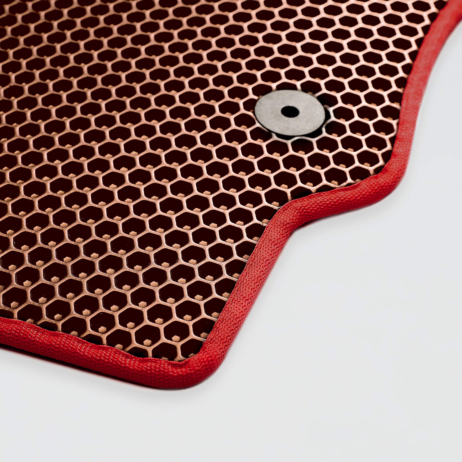 Red outlined hexagonal patterned mat with a circular metal fastener