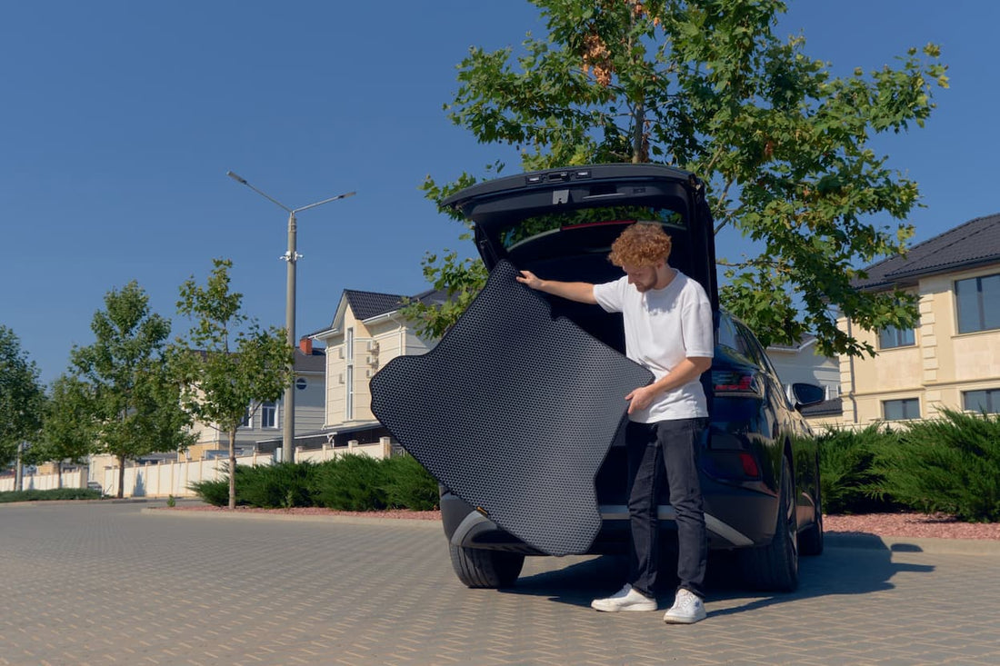 EVA car trunk mat being removed from vehicle, showing lightweight custom fit protection against dirt and spills.