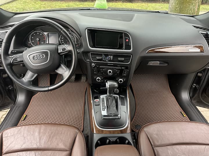 Custom fit car floor mats in brown installed in Audi front cabin