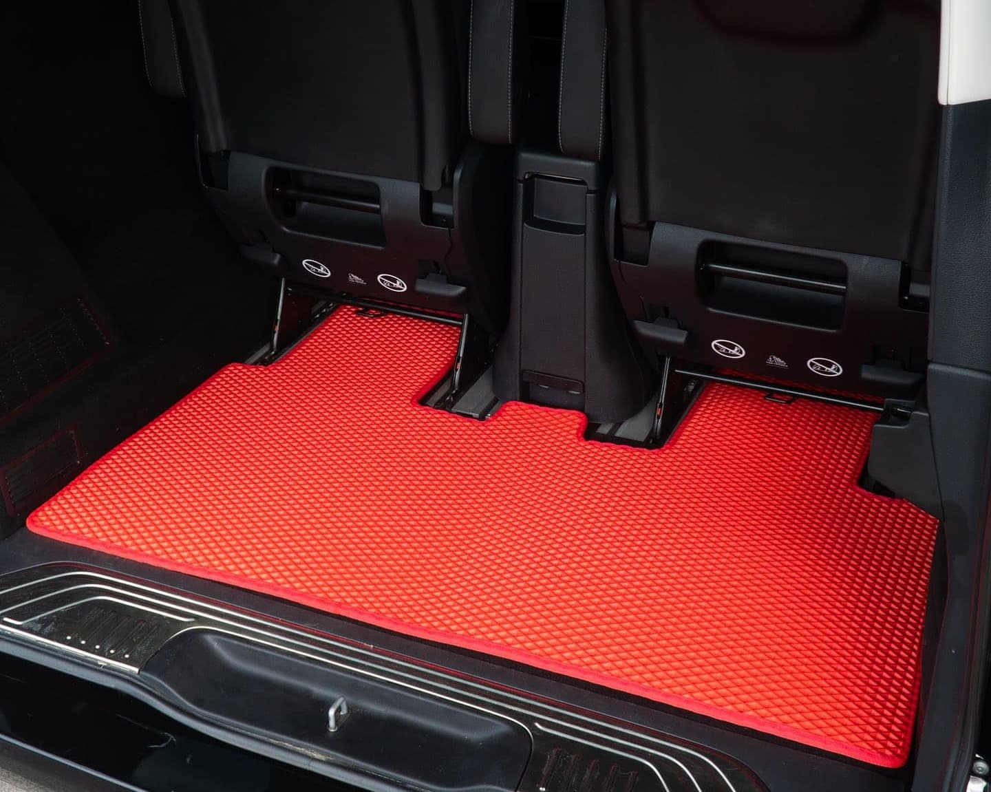 Red EVA car trunk mat precisely cut to fit third-row seat area, enhancing protection and style.