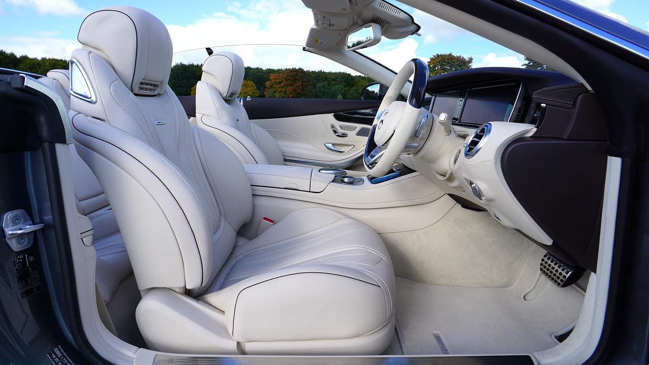 Luxurious white leather interior of a convertible with premium seating.