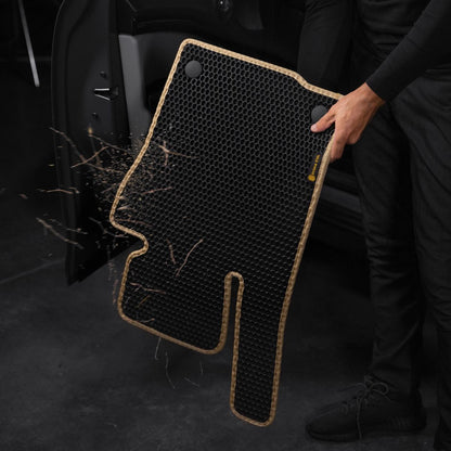 Black car floor mat with honeycomb structure, easily shaken off for cleaning.