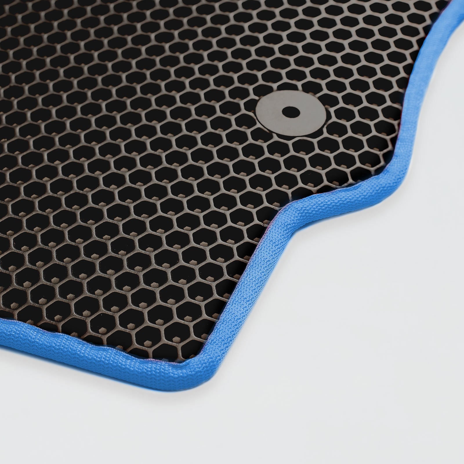 Close-up of a black hexagonal patterned mat with a blue edge