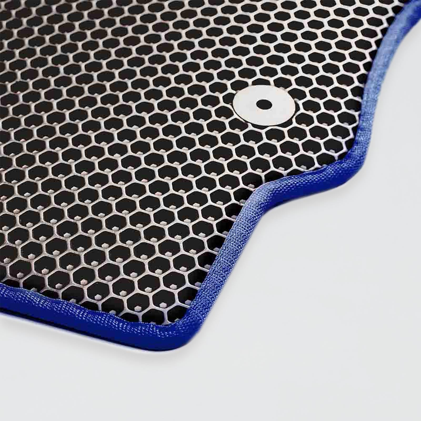 Close-up of a black honeycomb mesh with a blue border and a silver fastener.