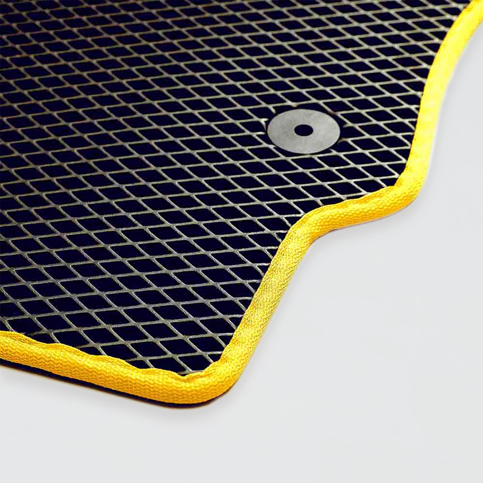 Close-up of a black rubber mat with a yellow border and circular hole.