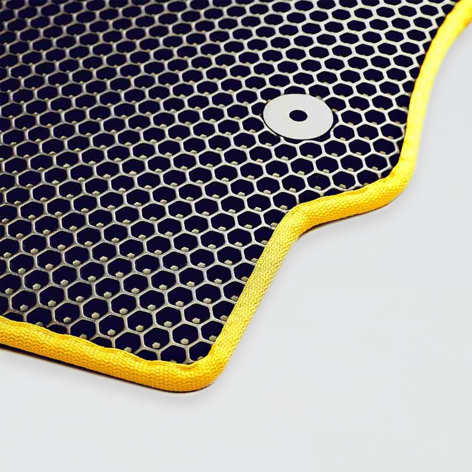 Black hexagonal mesh material with yellow edge and circular silver grommet