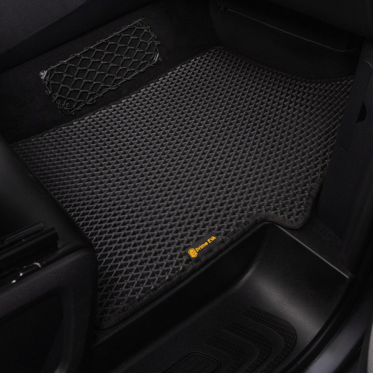 Black textured car floor mat in a passenger seat area, designed for durability.