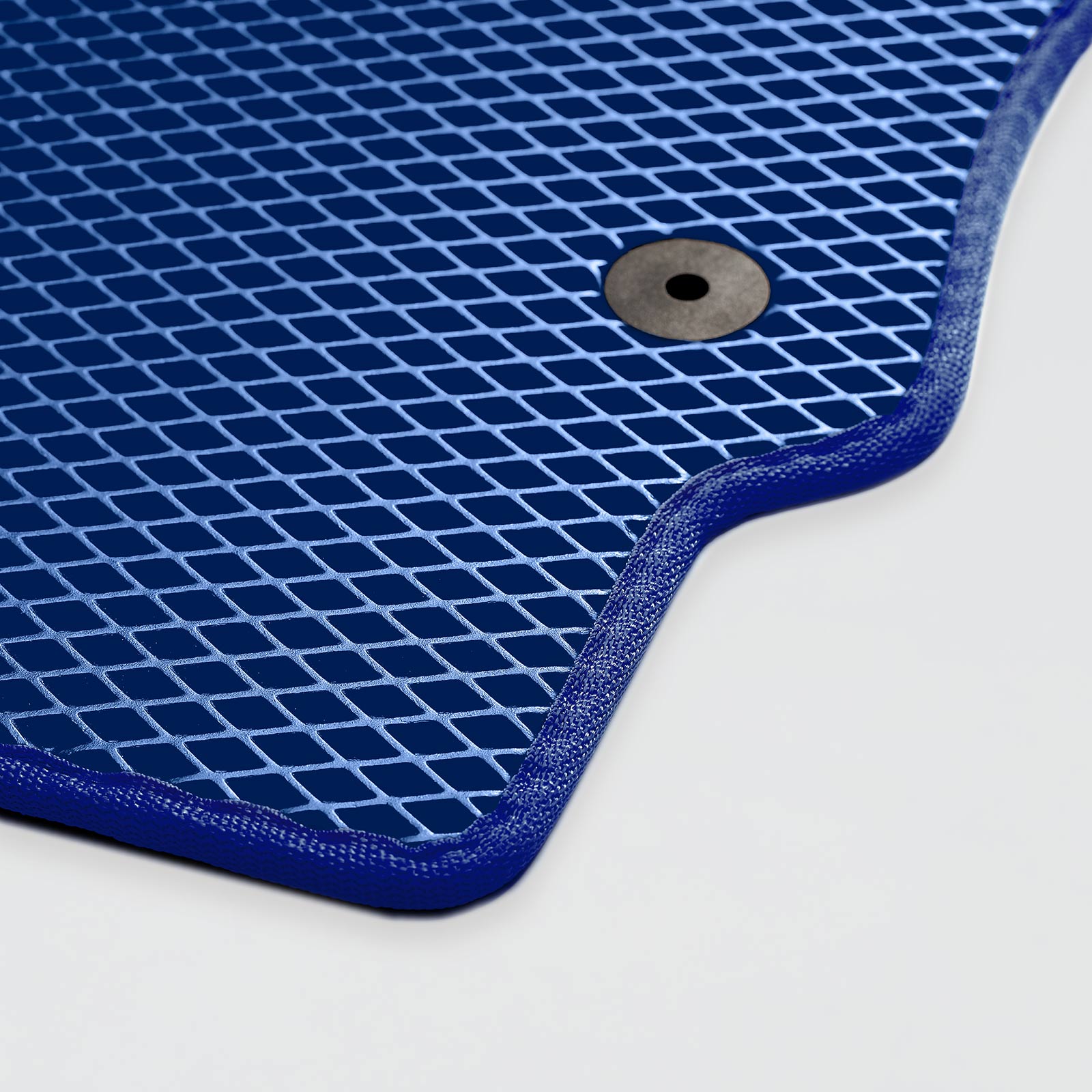 Textured blue rubber car mat with a circular hole for fastening.