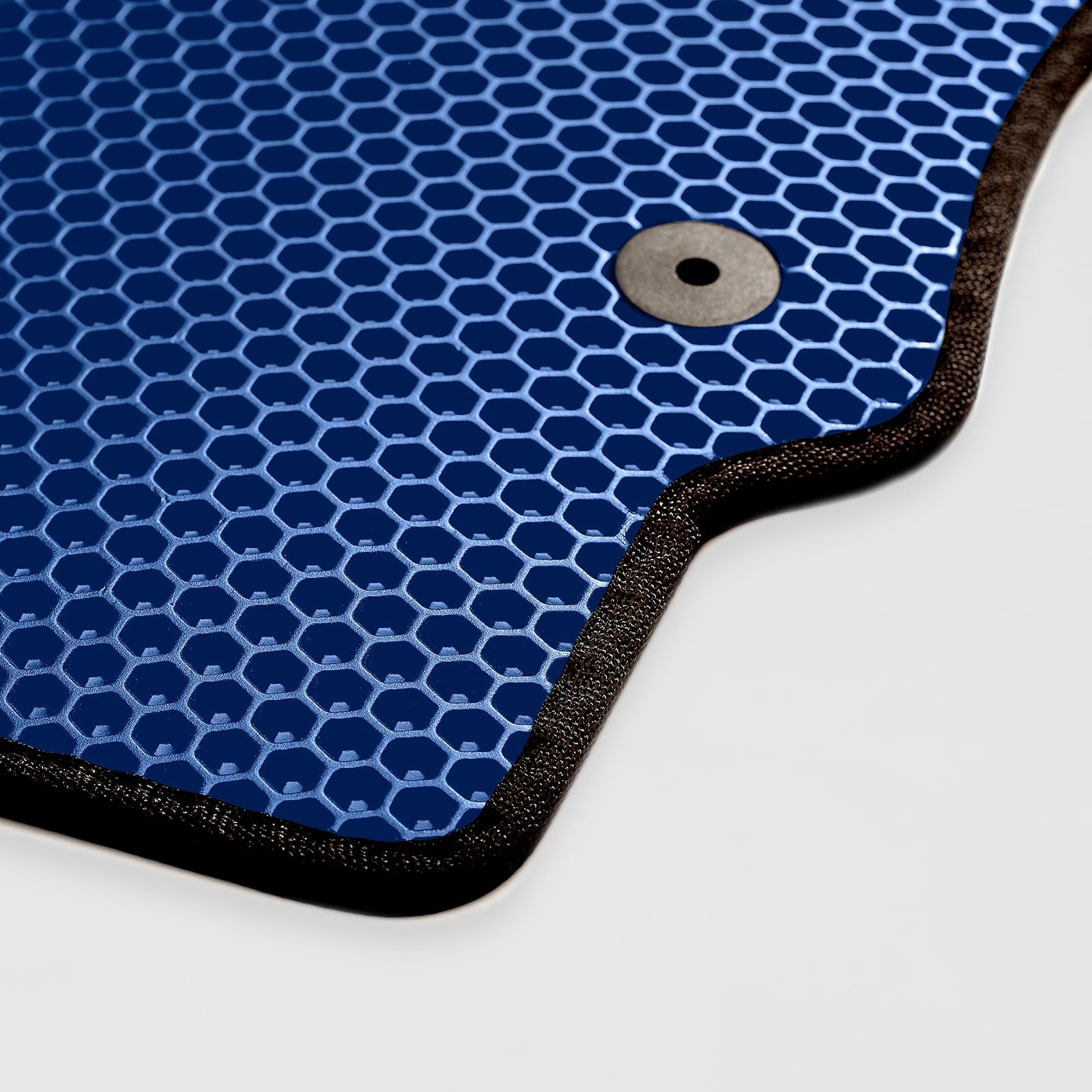 Blue honeycomb-patterned mat with black trim and a grommet on one side.