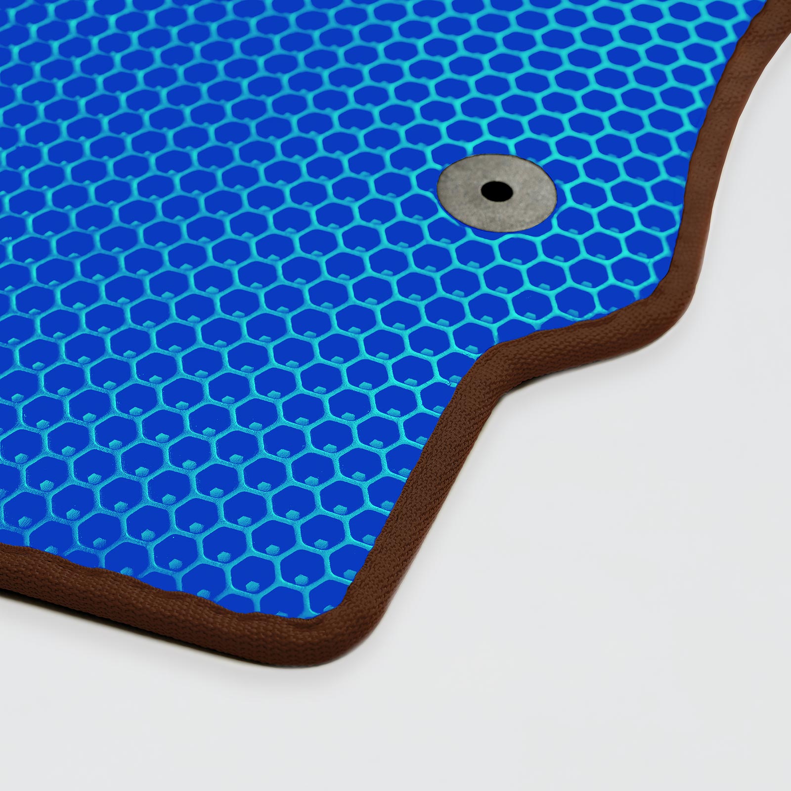 Blue honeycomb-patterned mat with a brown border and a metal grommet.