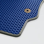 Blue honeycomb textured mat with a metal eyelet for hanging or securing.