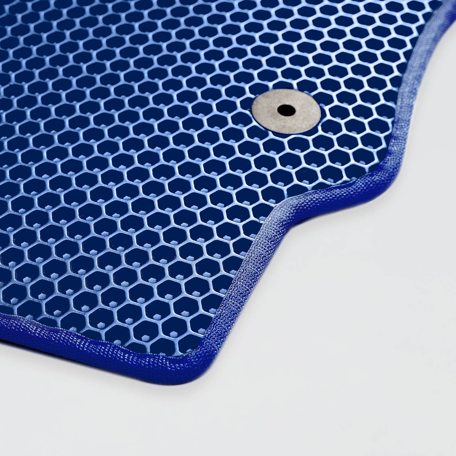 Close-up of a blue honeycomb-patterned product with a metal fastener.