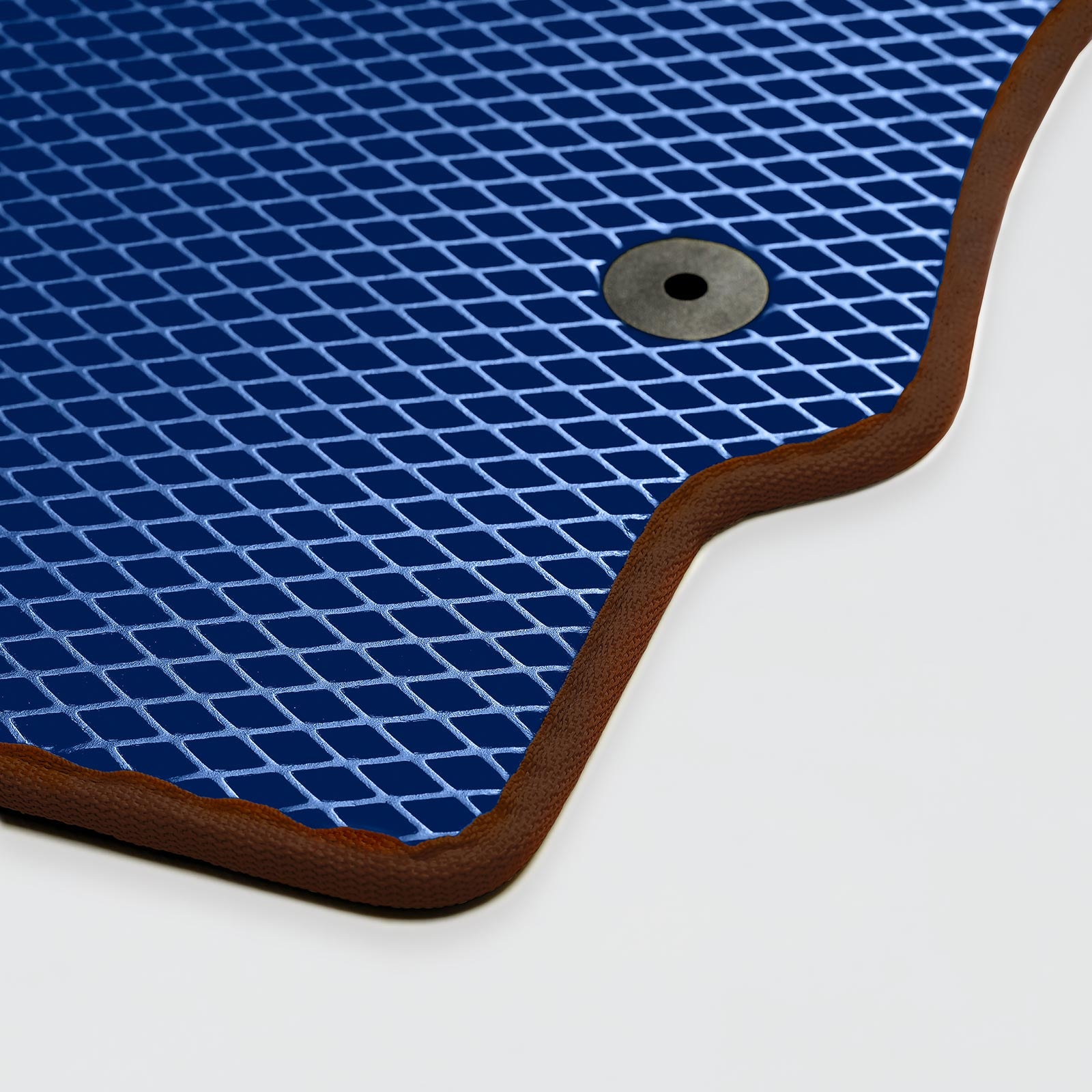 Blue rubber mat with a textured surface and circular hole for drainage.