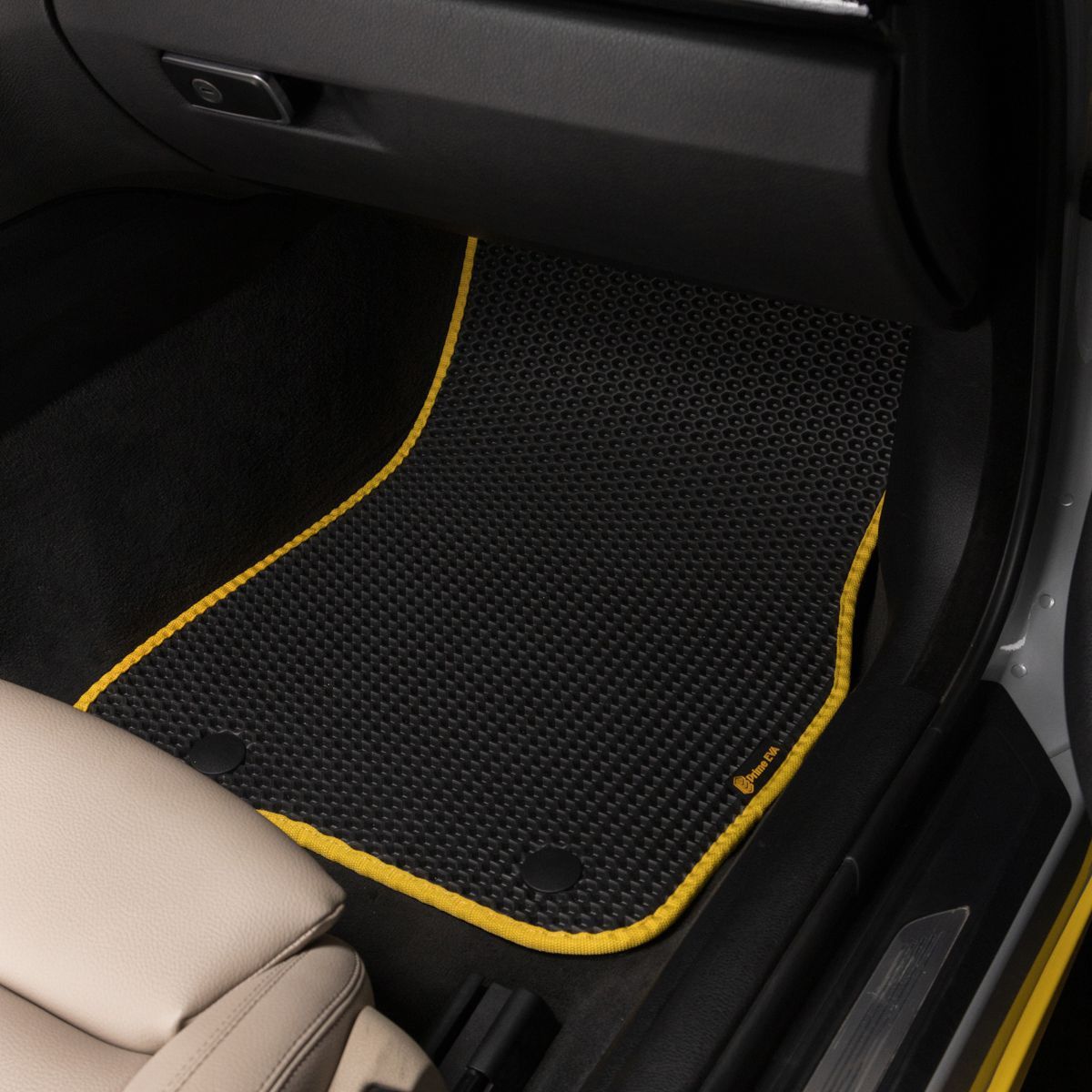 Black passenger-side car mat with yellow trim, designed for BMW interior.