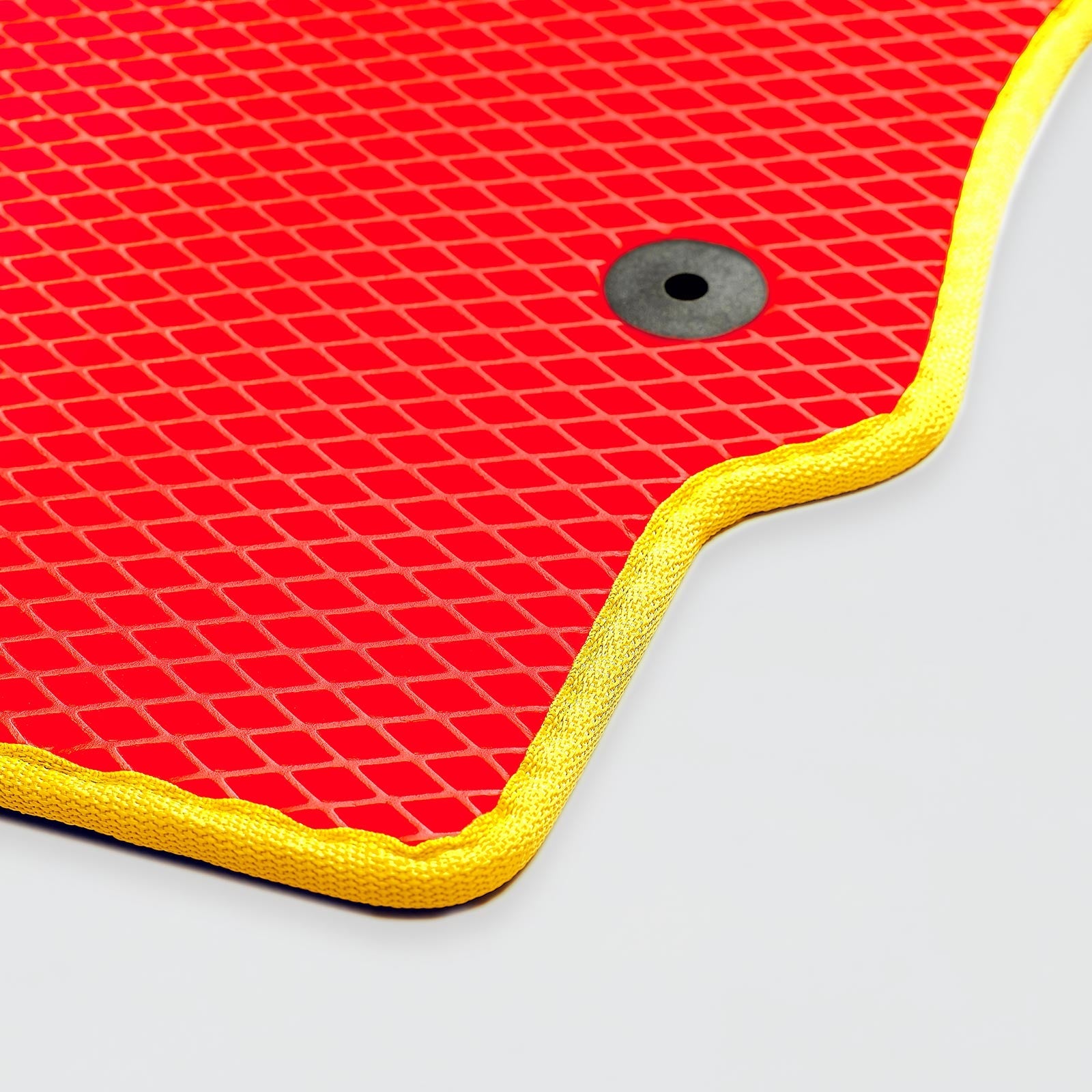 Bright red textured mat with yellow edge and circular hole.