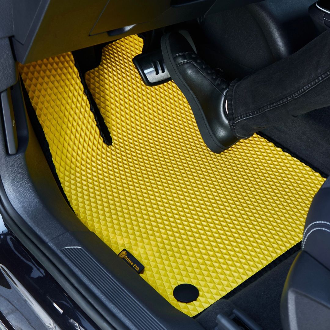 Bright yellow car floor mat with a textured pattern, enhancing interior style.