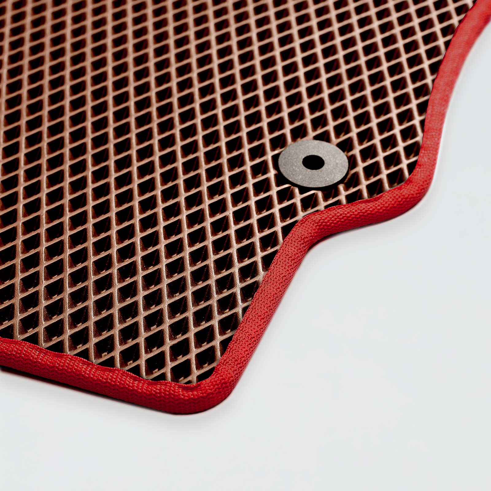 Brown rubber mat with red border and circular hole on edge.