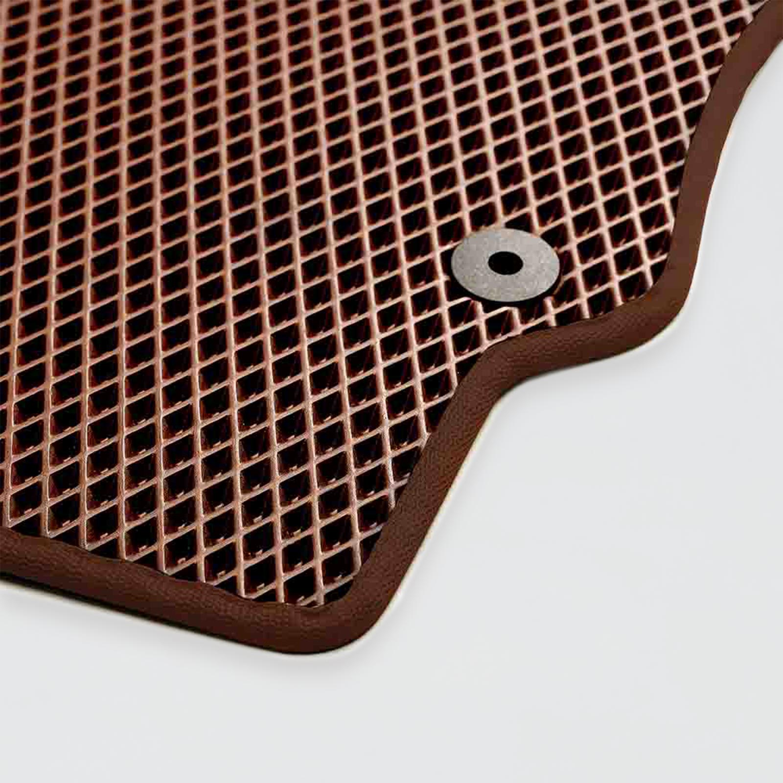 Brown rubber mat with a textured surface and a circular metal grommet.