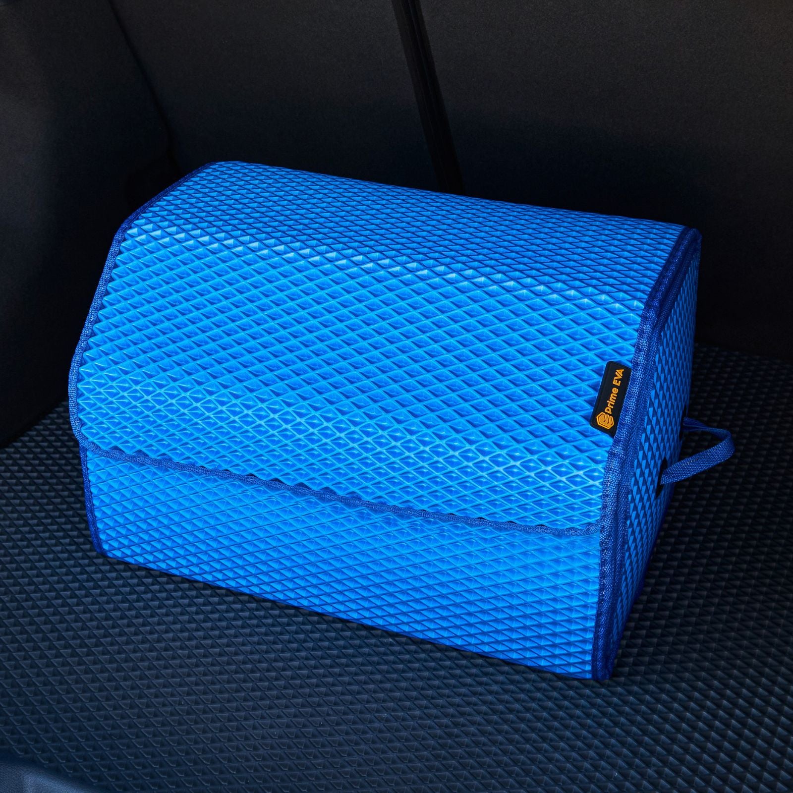 Large blue car trunk organizer on black mat for tidy storage.