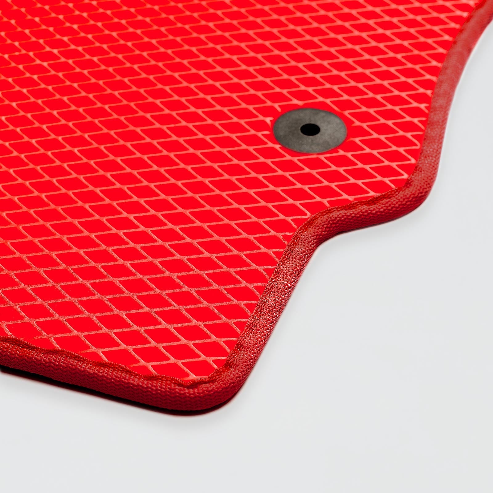 Red textured rubber mat with a circular hole in the corner for drainage.