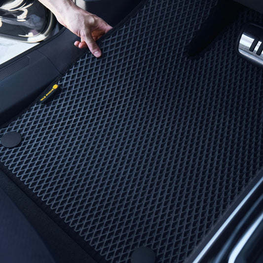 Durable black custom-fit EVA car floor mat in vehicle.