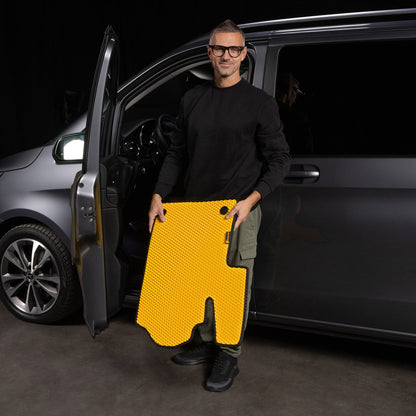 Man holding a custom EVA car mat designed for a van, ensuring a perfect fit and superior protection.