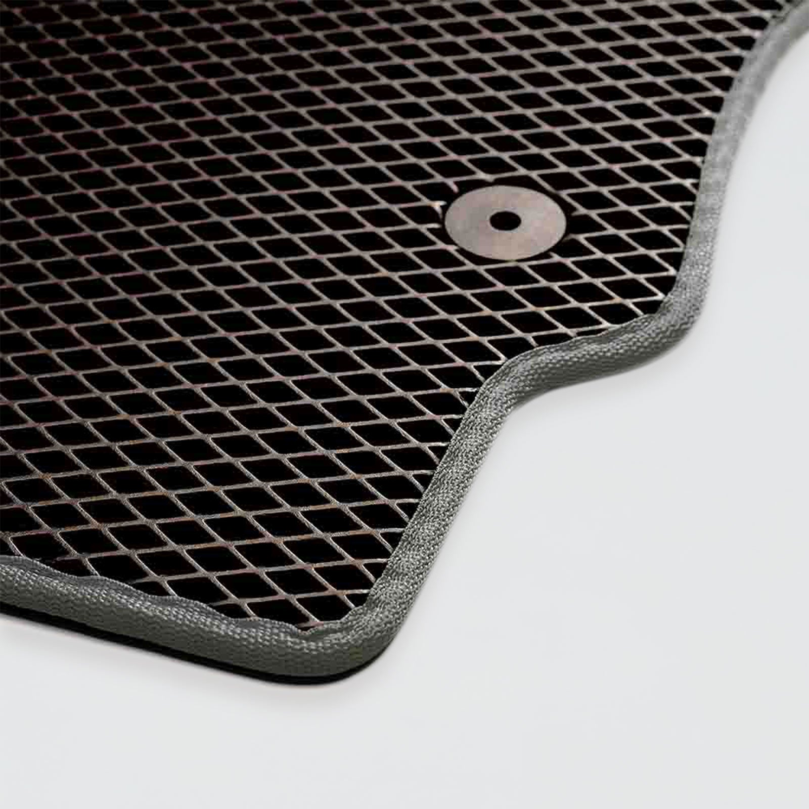 Black rubber mat with a textured grid pattern and rounded edges