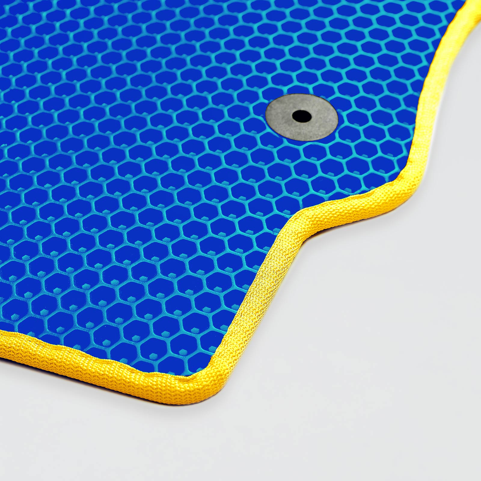 Blue honeycomb-patterned mat with yellow edges and a grey circular detail