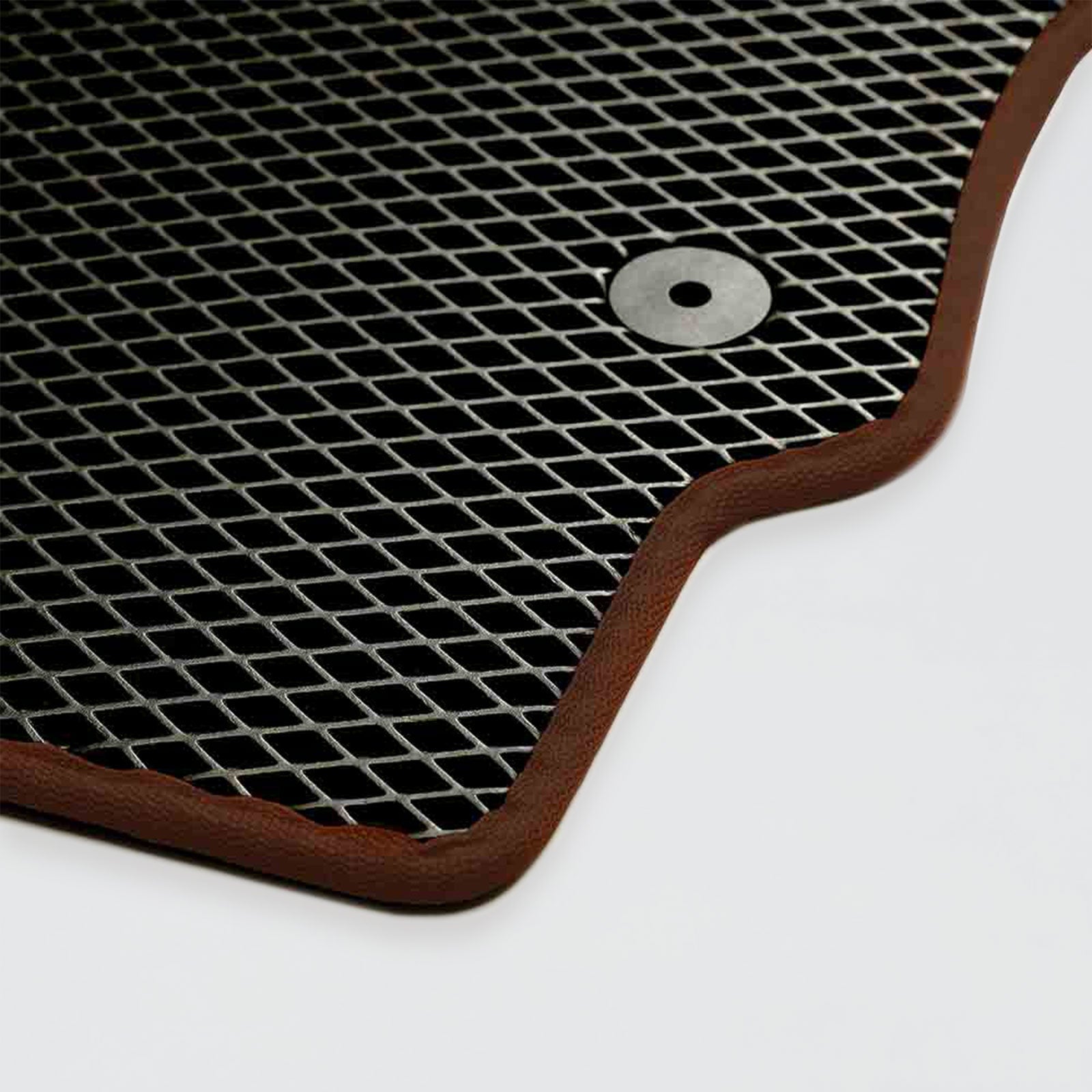 Textured black rubber mat with a brown border and circular grommet.