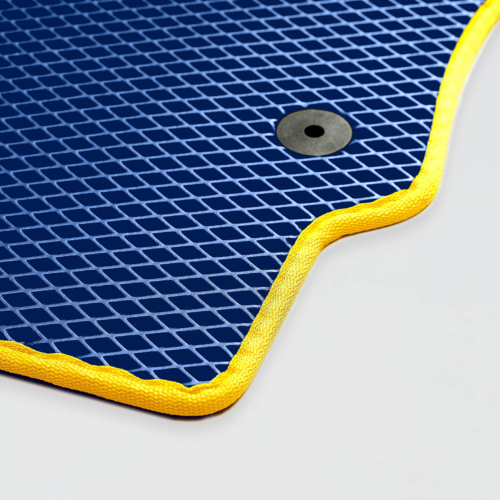 Navy blue textured mat with yellow edges and a metal grommet.