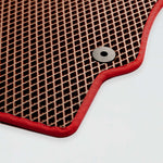 Red-edged rubber mat with a textured surface and a metal grommet