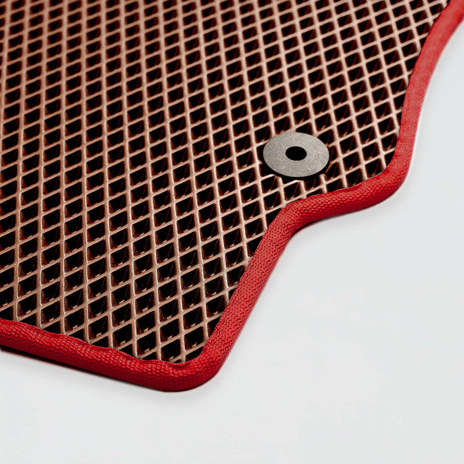 Red-edged rubber mat with a textured surface and a metal grommet