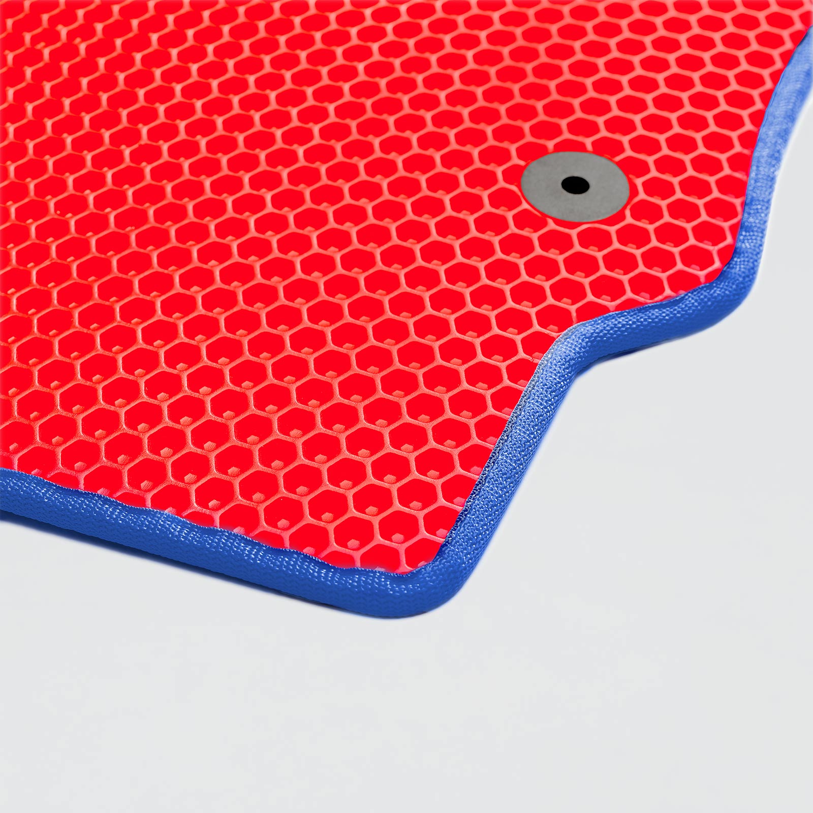 Red textured fitness mat with blue edging and circular hole in the corner