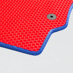Red textured mat with blue edging and a circular hole in the corner.