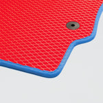 Red textured mat with blue edges and a round black hole for drainage