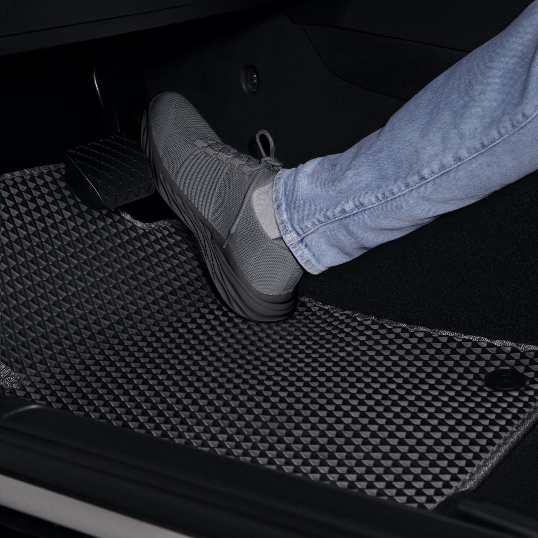 Black EVA car floor mat with shoe for vehicle interior protection.