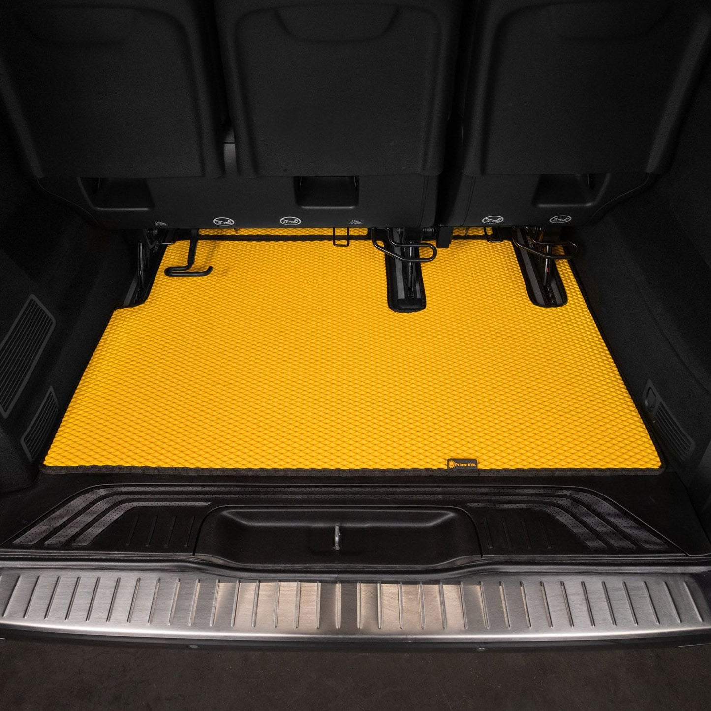 Bright yellow textured cargo floor mat in a van, designed for durability.