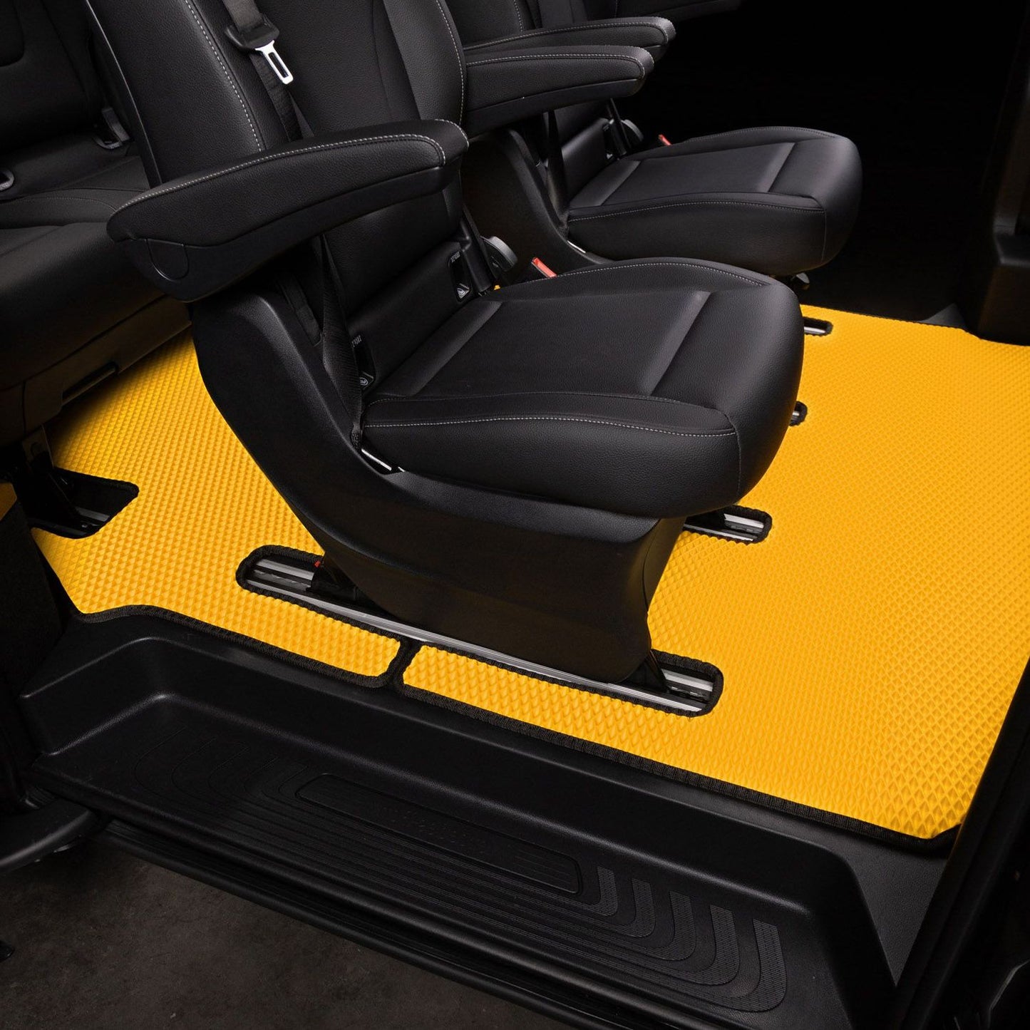 Bright yellow floor mat in a van interior, providing a stylish contrast.