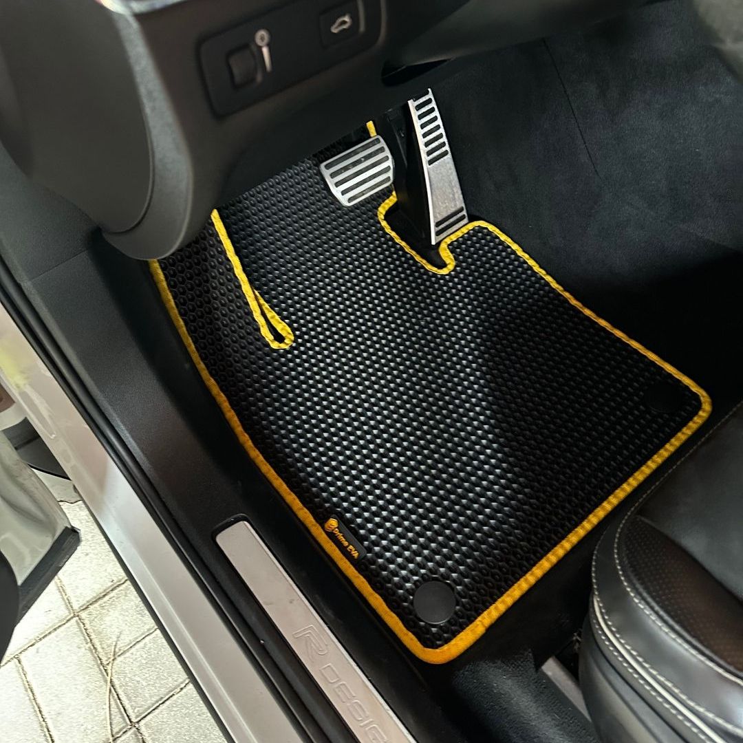 Black and yellow car mat custom-fitted for a Volvo R-Design interior.