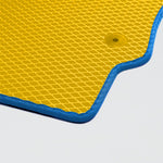 Yellow textured mat with blue edges and a circular hole, suitable for various activities.